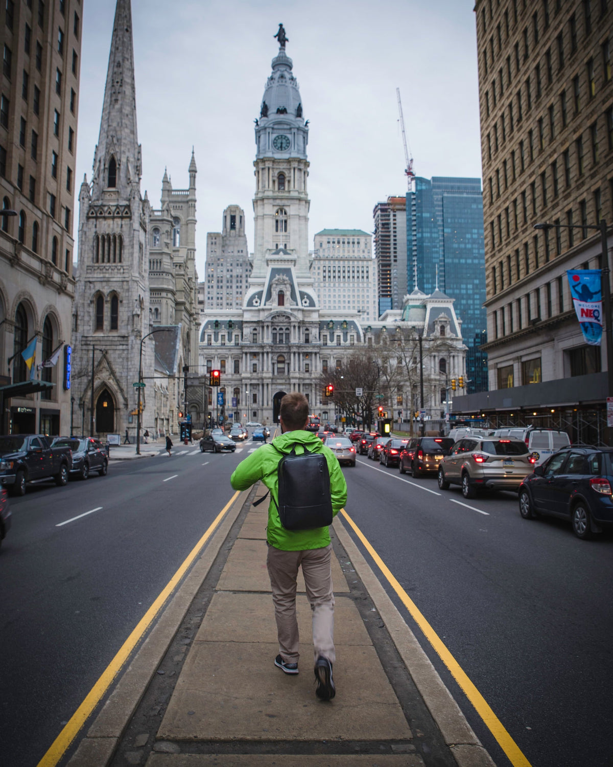 Man walking toward Philadelphia City Hall while wearing the black Nordweg Nomad leather laptop backpack