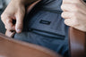 Close-up of the caramel Nordweg Nomad leather laptop backpack gray interior zip pocket
