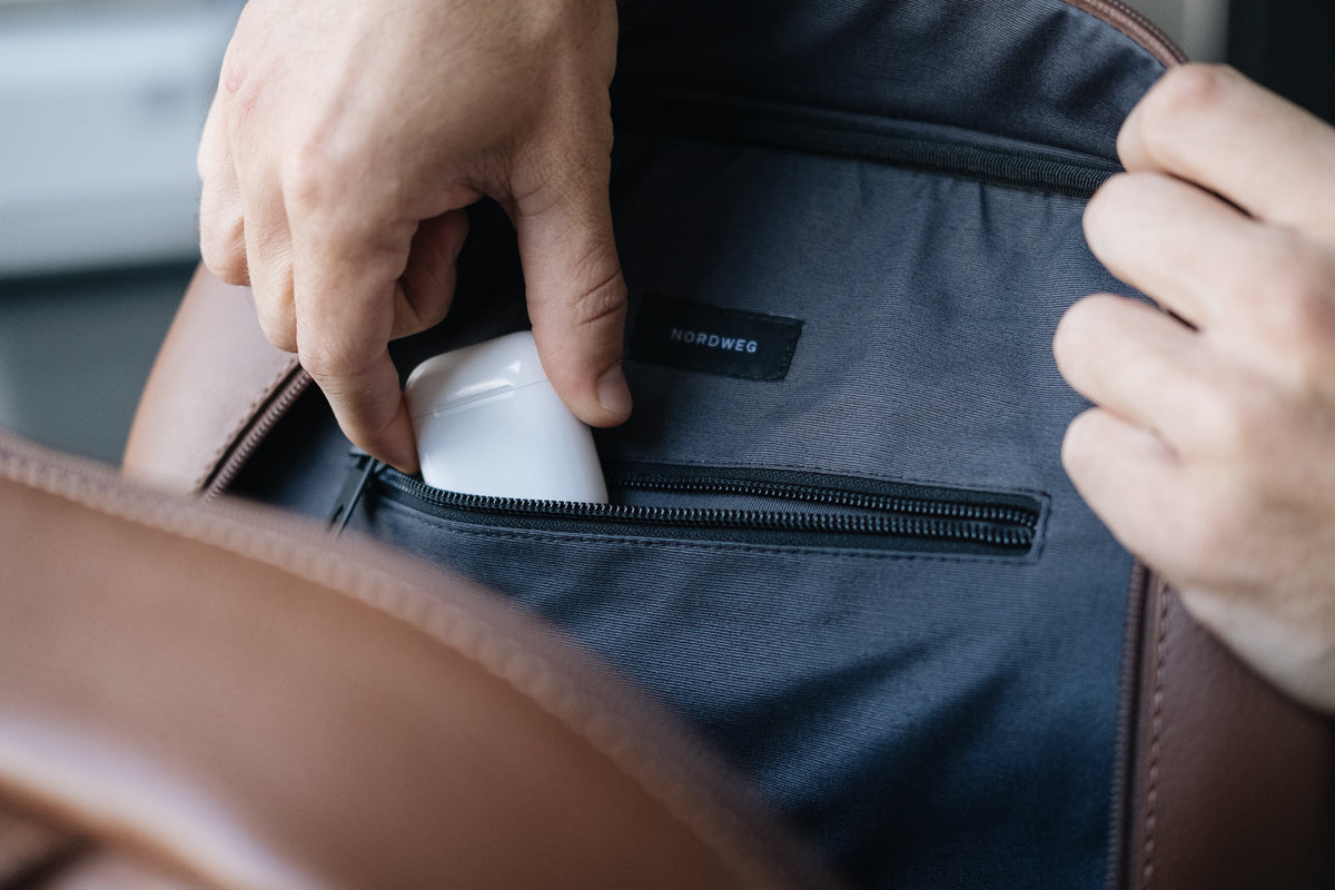Close-up of a laptop inside the caramel Nordweg Nomad leather laptop backpack padded interior sleeve