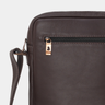 Close-up of the front zipper pull and side strap on the Nordweg Nomad Crossbody Bag in Coffee.