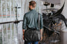 Nordweg Nomad black leather briefcase carried over the shoulder in a modern interior, SKU NW080A.IP, GTIN 7898571000696