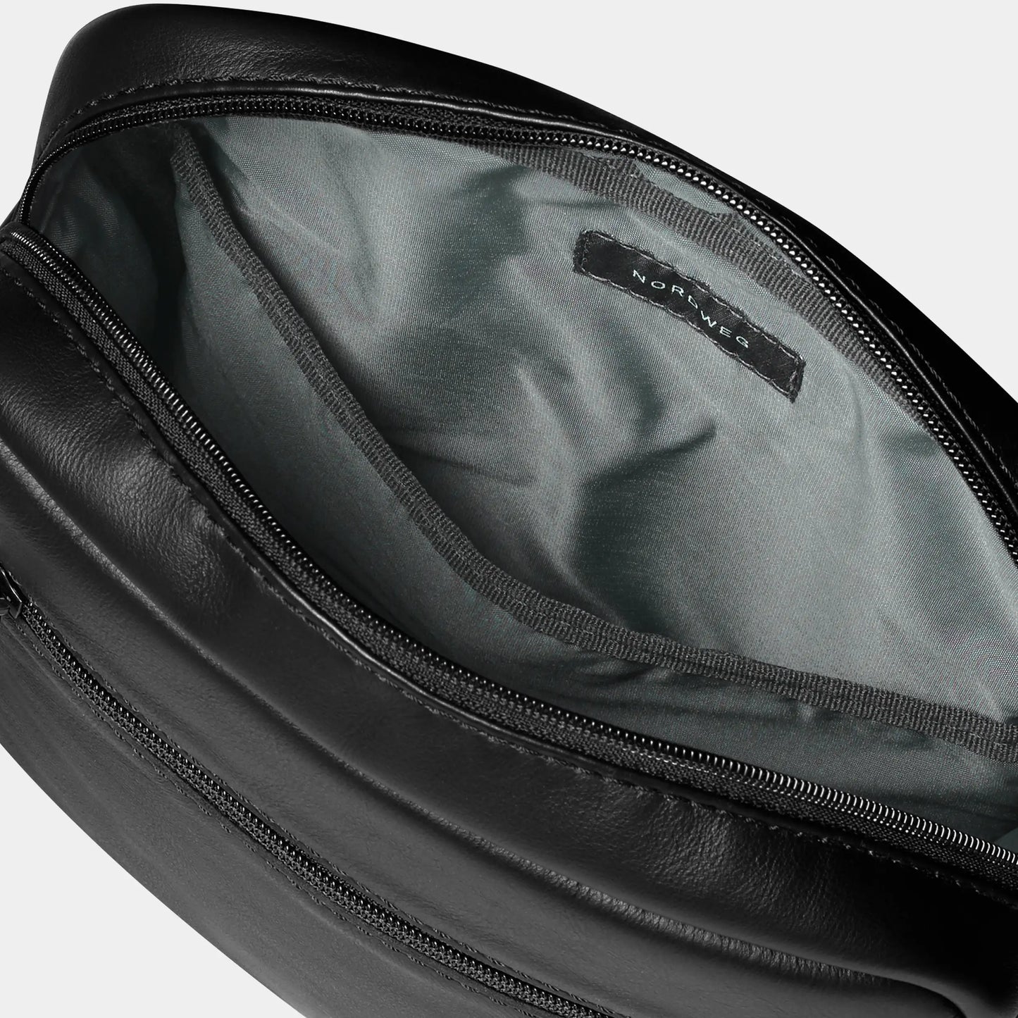 Open black Nordweg Nomad leather crossbody bag showing its lined interior and label, SKU NW091A.IP, GTIN 7898571000962