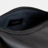 Open black Nomad leather dopp kit showing dark blue lining and Nordweg label
