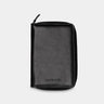 Nordweg Nomad leather passport wallet in black, front view with zip-around closure