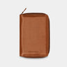 Nordweg Nomad leather passport wallet in caramel, front view with zip-around closure