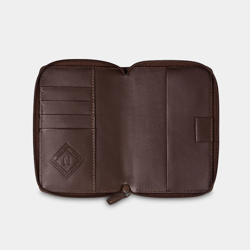Open coffee Nomad leather passport wallet showing card slots and passport pocket