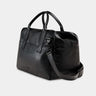 Nordweg Nomad leather weekender duffel bag in black, side view with shoulder strap