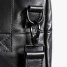 Close-up of black Nordweg Nomad leather weekender strap and hardware detail