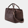 Nordweg Nomad leather weekender duffel bag in coffee, side view with shoulder strap