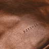 Close-up of the exact embossed NORDWEG logo and leather grain on the Nomad Weekender in Caramel.