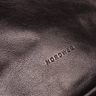 Close-up of the exact embossed NORDWEG logo and leather grain on the Nomad Weekender in Coffee.