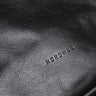 Nordweg NW081A Nomad leather weekender duffel in Black, logo detail view, SKU NW081A.IP, GTIN 7898571000726