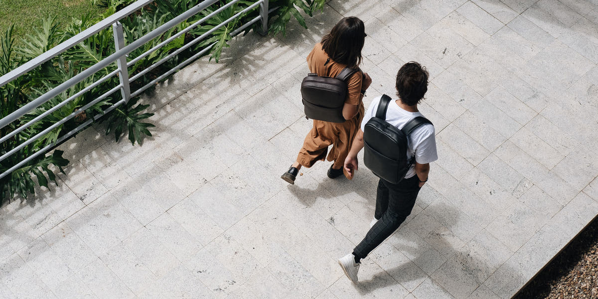 Nordweg NW108 Slim Workplace leather laptop backpack in Black, two-person overhead lifestyle banner