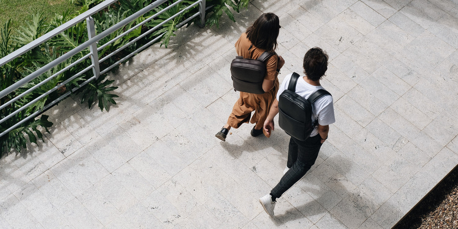 Nordweg NW108 Slim Workplace leather laptop backpack in Black, two-person overhead lifestyle banner, SKU NW108.IP, GTIN 7898571002089