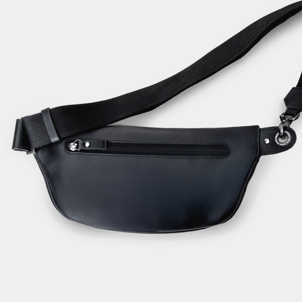 Nordweg Pulse leather sling crossbody bag in black, back view with adjustable strap and rear zip pocket