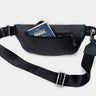 Black Pulse leather sling crossbody bag with rear pocket shown holding a card