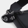 Close-up of black Pulse leather sling bag zipper lock and hardware detail