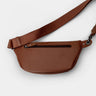 Nordweg Pulse leather sling crossbody bag in caramel, back view with adjustable strap and rear zip pocket