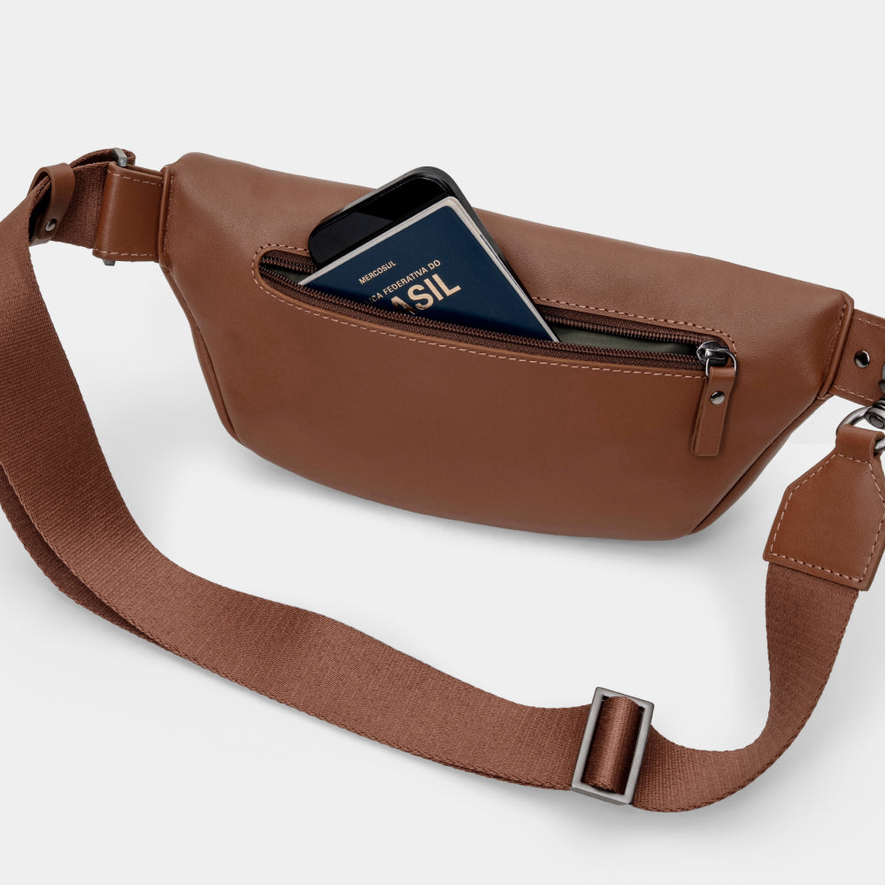 Caramel Pulse leather sling crossbody bag with rear pocket shown holding a card