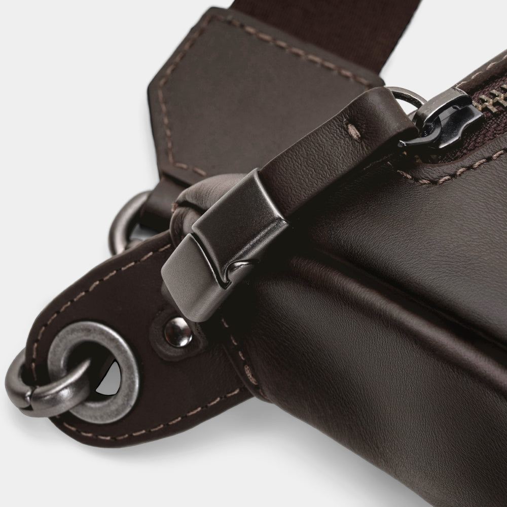 Close-up of coffee Pulse leather sling bag zipper lock and hardware detail