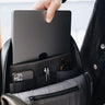 Black Slim Workplace backpack open to show the laptop sleeve and organizer pockets