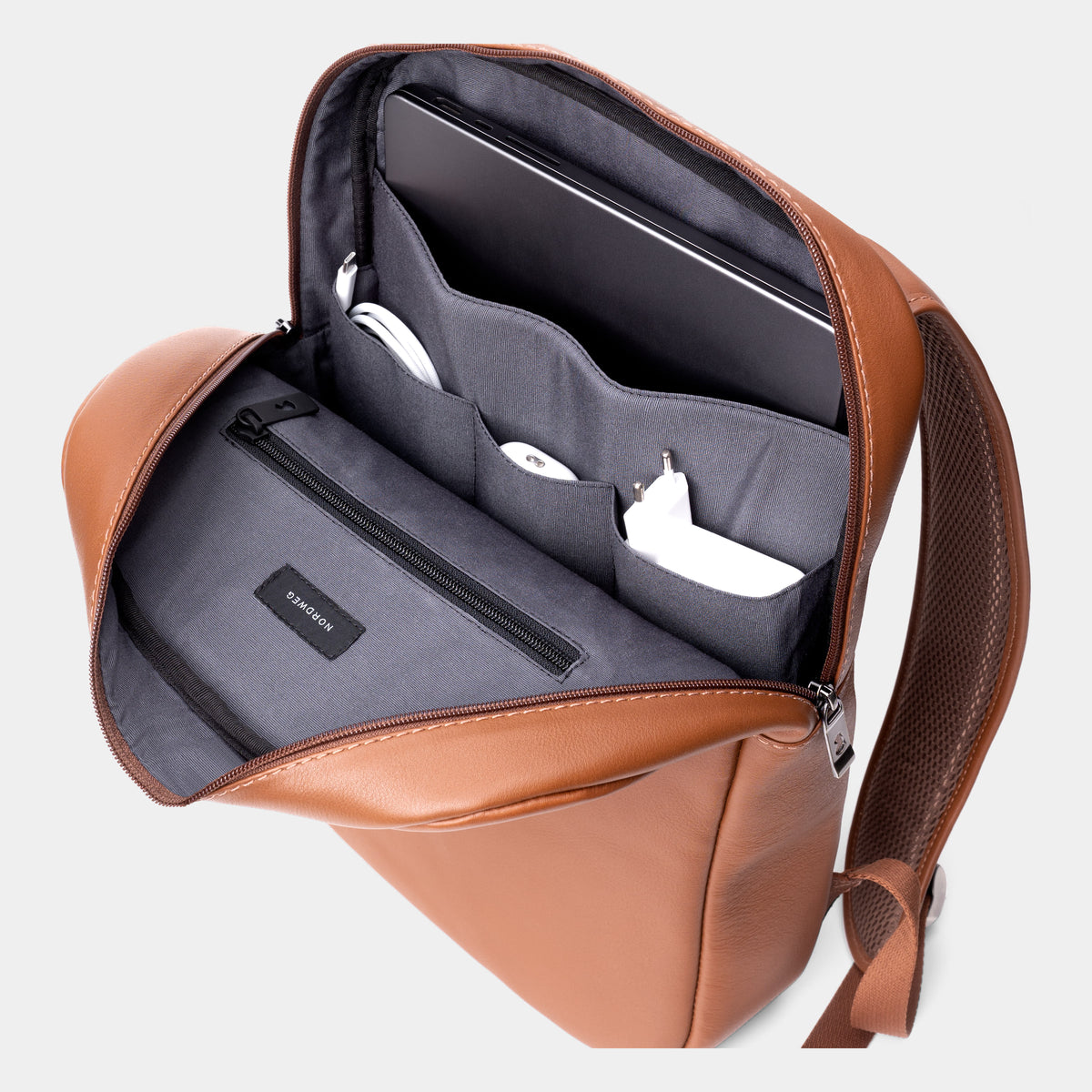 Caramel Slim Workplace backpack open to show the laptop sleeve and organizer pockets