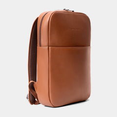 Nordweg Slim Workplace Laptop Backpack in Caramel, three-quarter front view with front pocket and shoulder strap.