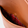 Close-up of caramel Slim Workplace leather laptop backpack pocket with plaid lining