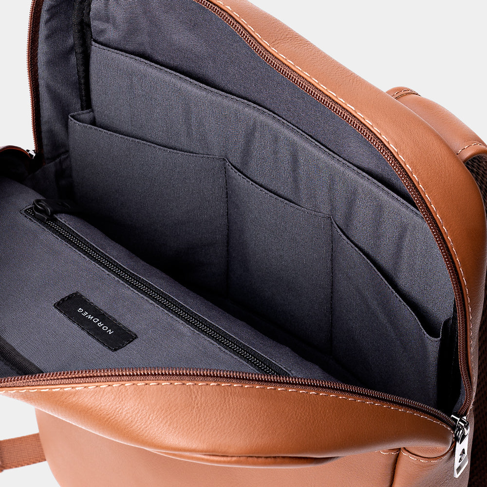 Open caramel Nordweg Slim Workplace leather laptop backpack showing gray interior pockets