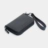 Black Traveler Pro AirTag leather wallet angled view with wrist strap safety loop