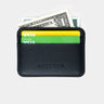 Black Traveler Pro AirTag wallet mini cardholder holding cards and cash