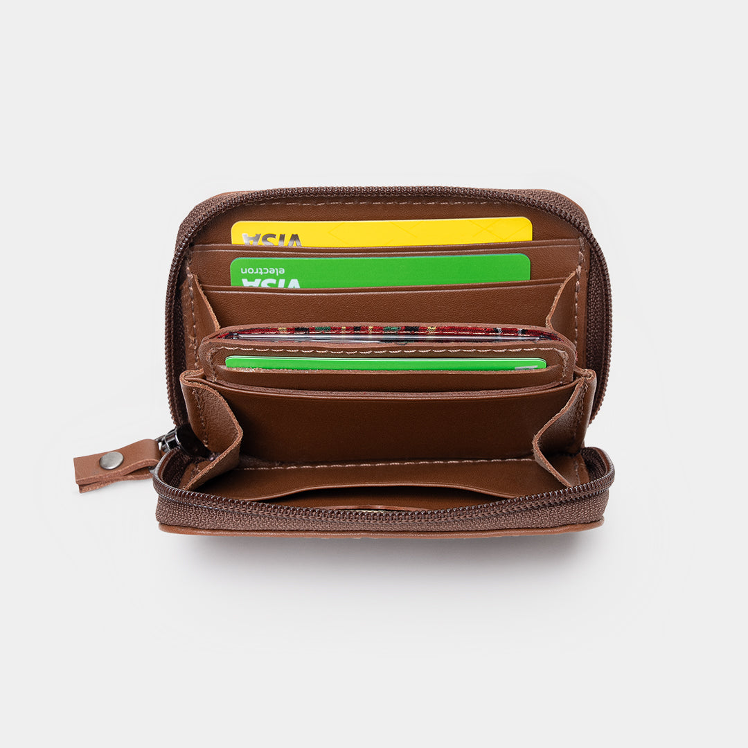 Open caramel Traveler Pro AirTag leather wallet showing card slots and cash pocket