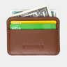 Caramel card sleeve from the Nordweg Traveler Pro Wallet shown with cards and cash.