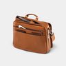 Open caramel Workday leather briefcase showing document pocket and front zip pocket