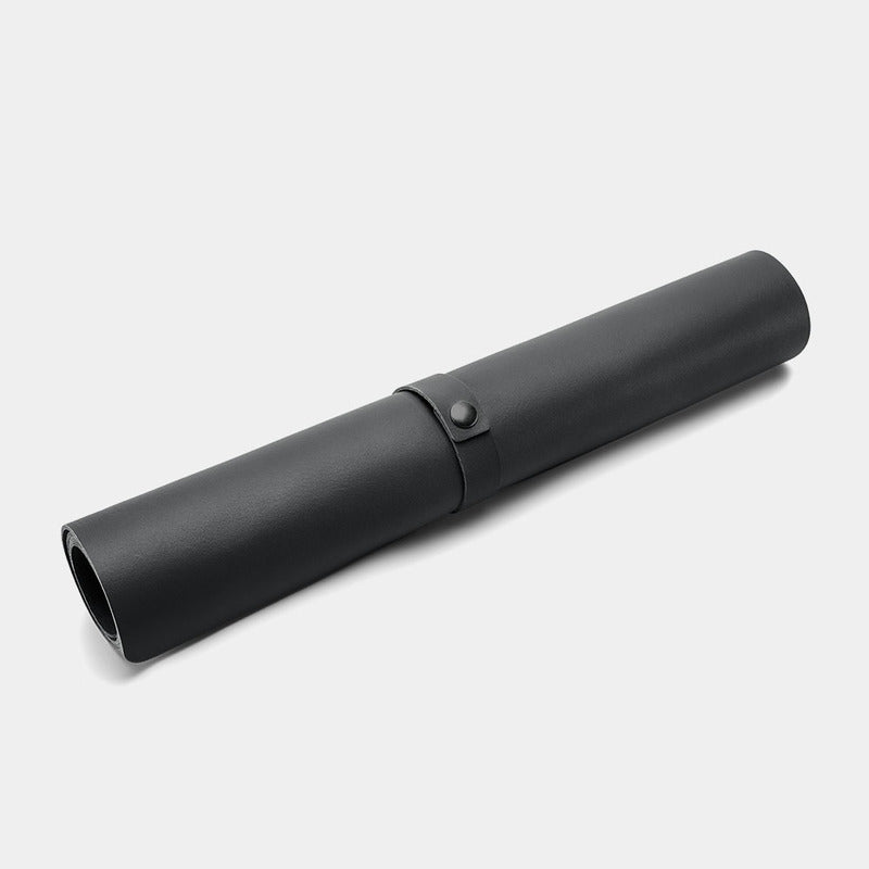 Nordweg Workplace leather desk pad in black, rolled view with strap