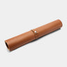 Nordweg Workplace leather desk pad in caramel, rolled view with strap