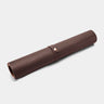 Nordweg Workplace leather desk pad in coffee, rolled view with strap