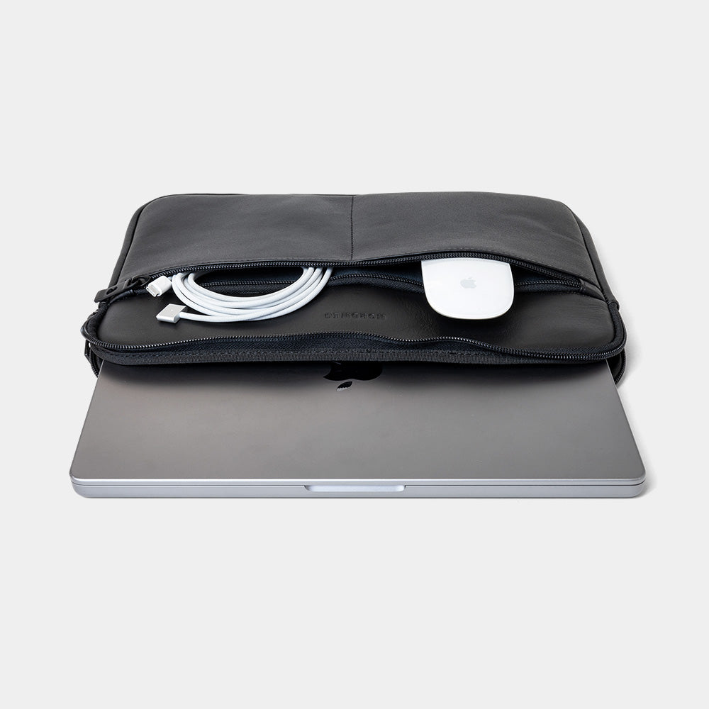 Black Workplace leather laptop sleeve case front pocket detail with cable and white accessory