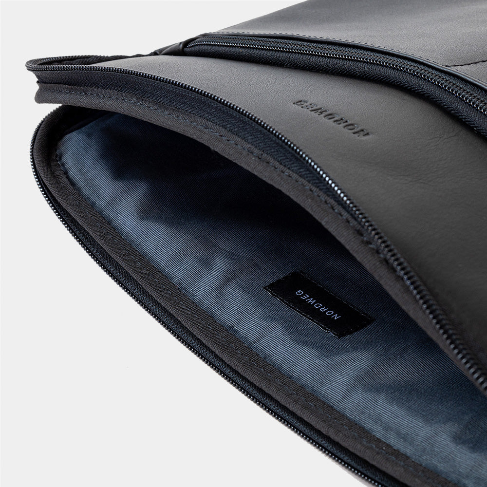 Open black Workplace leather laptop sleeve case showing padded gray lining