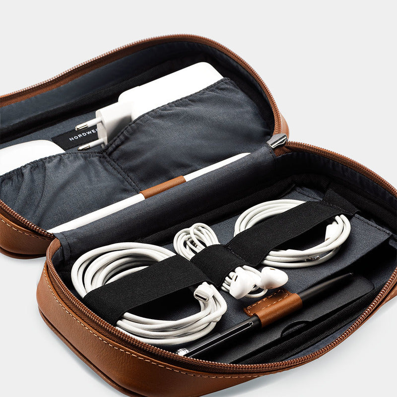 Open Workplace leather tech organizer showing cables secured under elastic straps