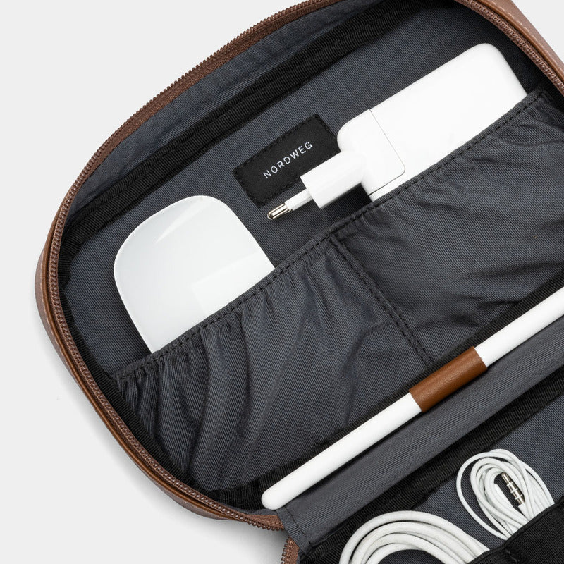 Close-up of open Workplace leather tech organizer with gray lining, charger, and stylus