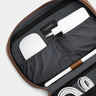 Close-up of open Workplace leather tech organizer with gray lining, charger, and stylus
