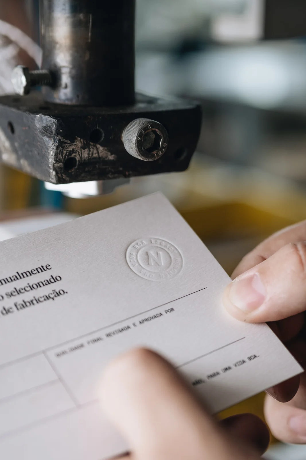 A card being held beneath the workshop stamp