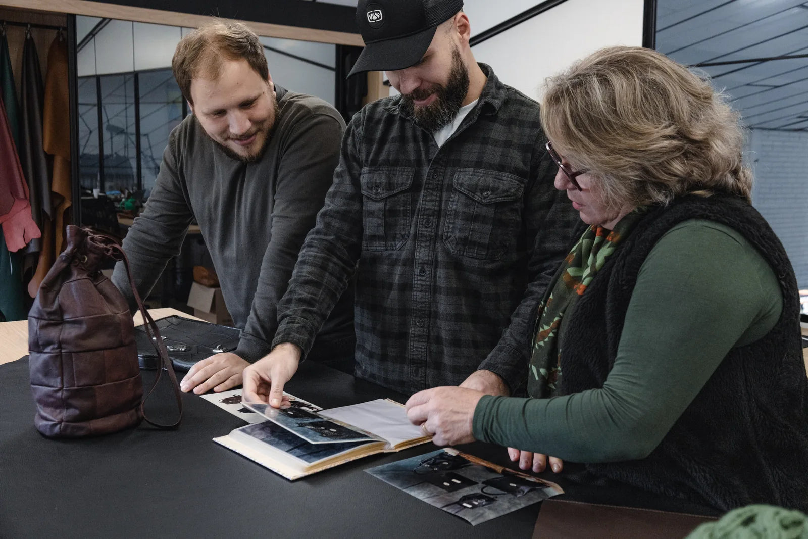 Iuri on the left, Igor and Marisa looking through family photographs