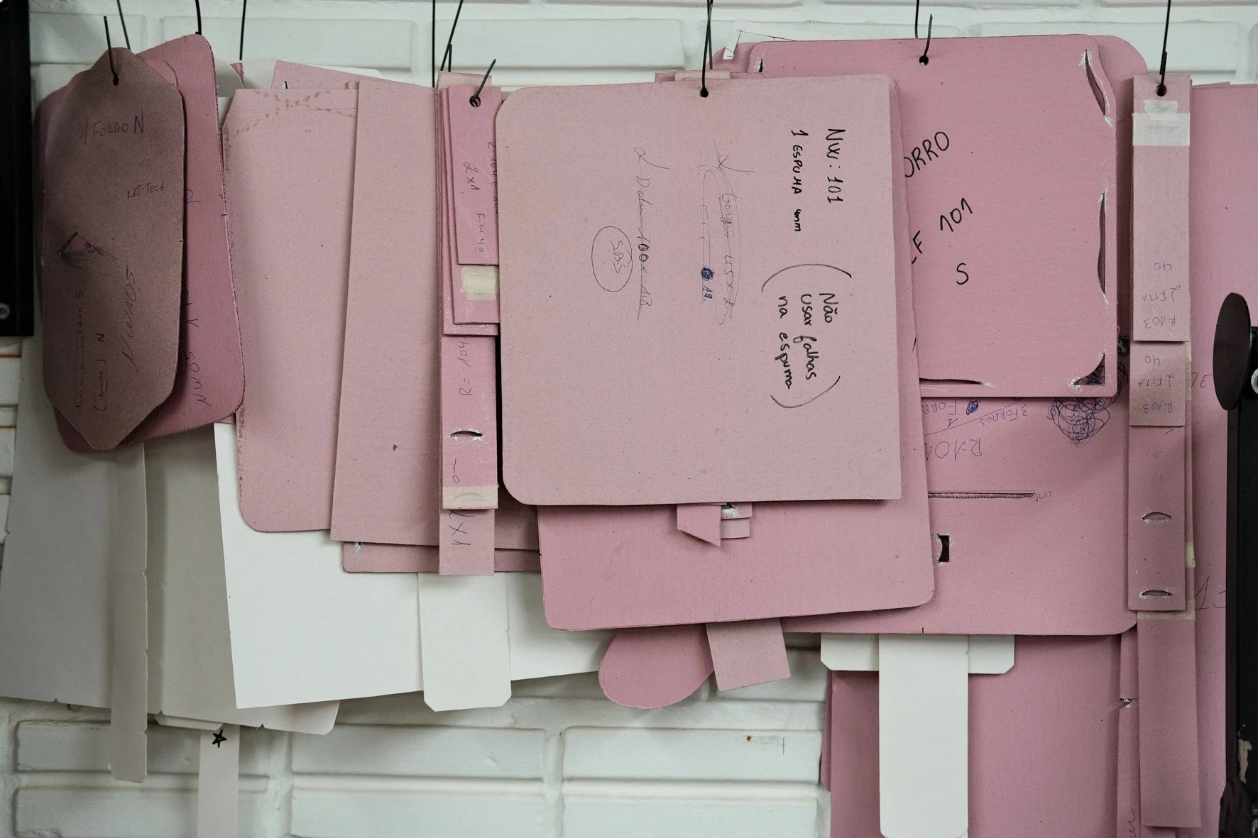 Paper cutting patterns hanging on the wall of the Nordweg workshop