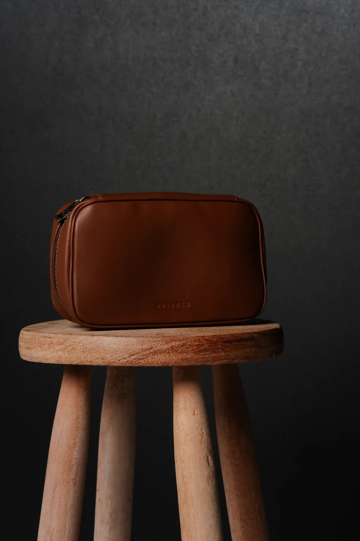 Caramel Workplace tech organizer on a wooden studio stool