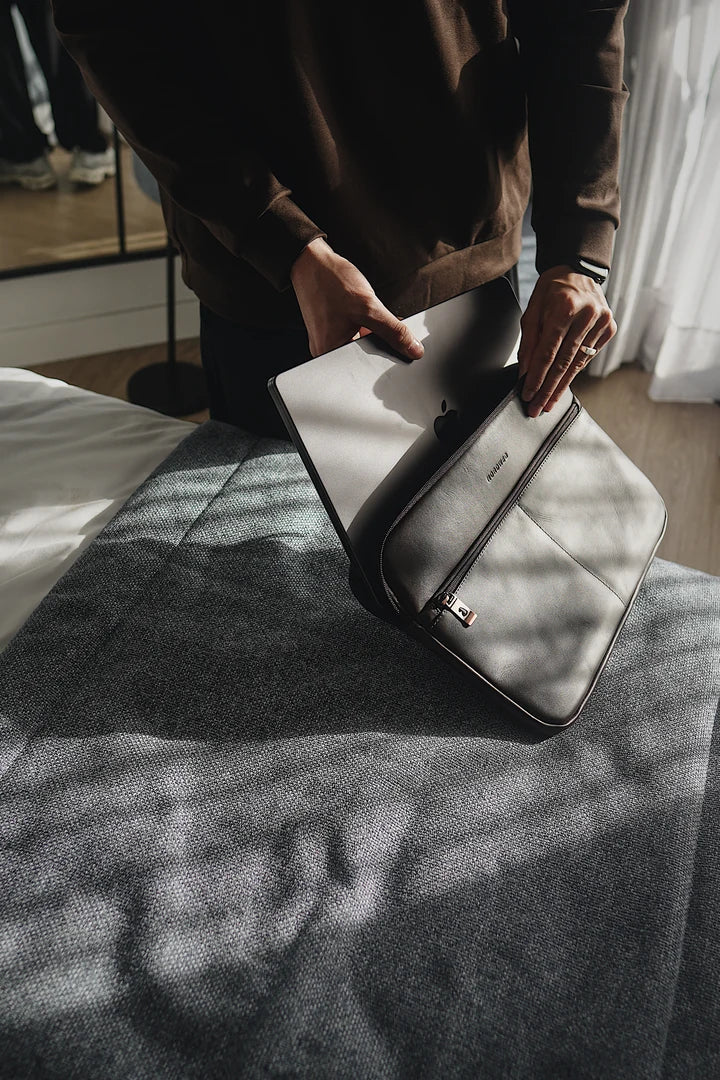 Laptop being packed into a Coffee Workplace laptop sleeve